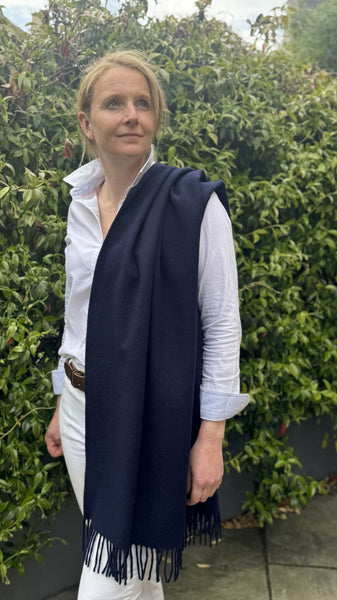 navy merino wool poncho worn over the shoulder